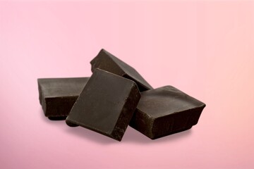 Tasty sweet chocolate bar on color background.