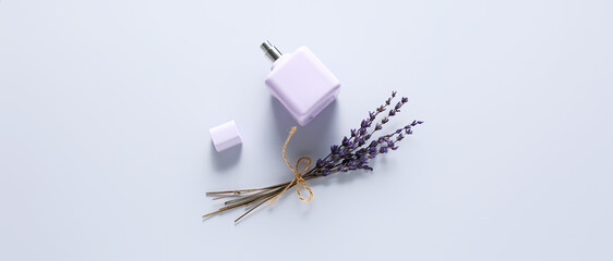 Bottle of lavender perfume on light background, top view