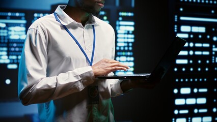 Engineer making sure servers in cloud computing business service are correctly equipped to provide redundancy, automatic failover and rapid reconfiguration of clusters to minimize failure of hardware