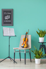 Chair with violin and note stand in room