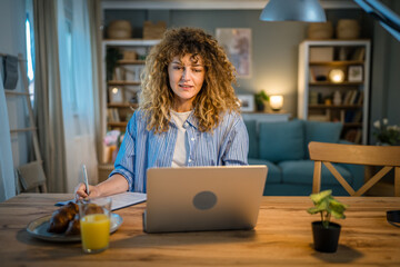 Fototapeta premium one woman adult caucasian work on her laptop at home happy smile