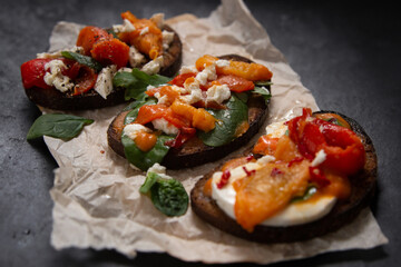 bruschetta set with herbs, cheese, and roasted peppers. 