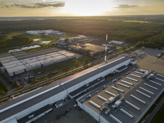 Industrial clean energy factory with tall ecological chimney at the evening industrial park area,...
