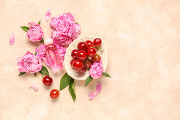 Composition with bottle of essential oil, grapes and peony flowers on color background