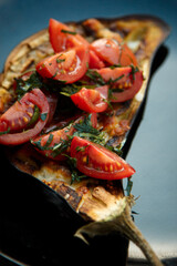baked eggplant with sliced cherry tomatoes.