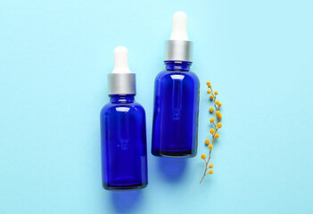 Bottles of  healthy essential oil on color background