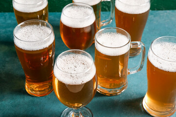Glasses and mug of cold beer on green background. Oktoberfest celebration
