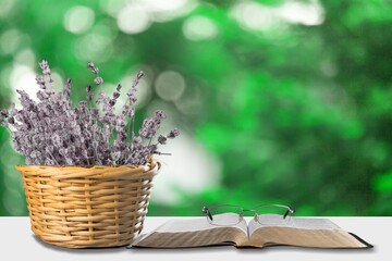 Christian bible book and a bouquet of flowers in basket