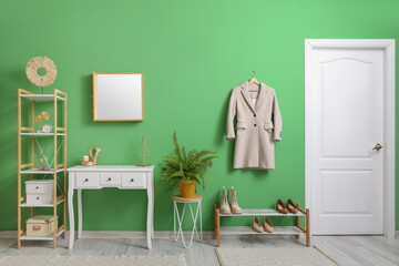 Interior of modern hallway with dressing table, mirror and coat