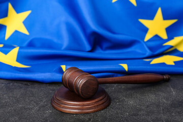 Judges gavel and flag of European Union on black table