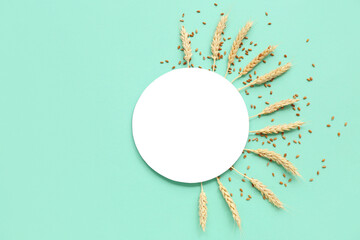 Blank card with wheat ears and grains on turquoise background