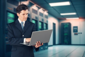 Futuristic Concept: Business man with laptop in Data Center