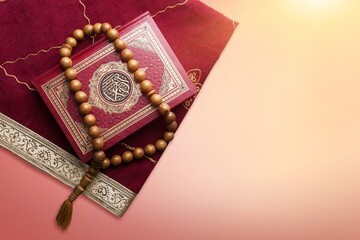 Holy Quran book with written calligraphy and rosary beads