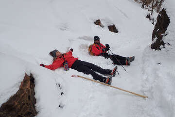 Hikers making snow angels on the Riverside Walk in winter  at Zion National Park, Utah