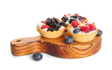 Wooden board of tasty tartlets with whipped cream and berries on white background