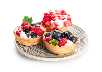 Plate of tasty tartlets with whipped cream and berries on white background