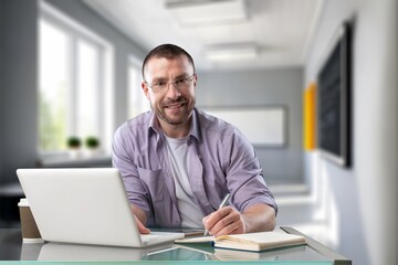 Young happy business person or teacher with laptop computer