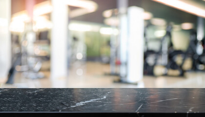 Empty black marble stone table top on blurred with bokeh Exercise room, fitness and gym interior background - can be used for display or montage your products
