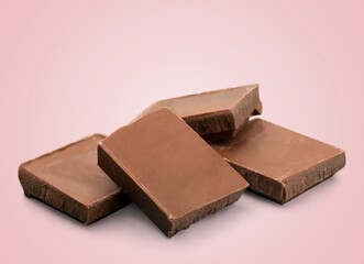 Tasty sweet chocolate bar on color background.