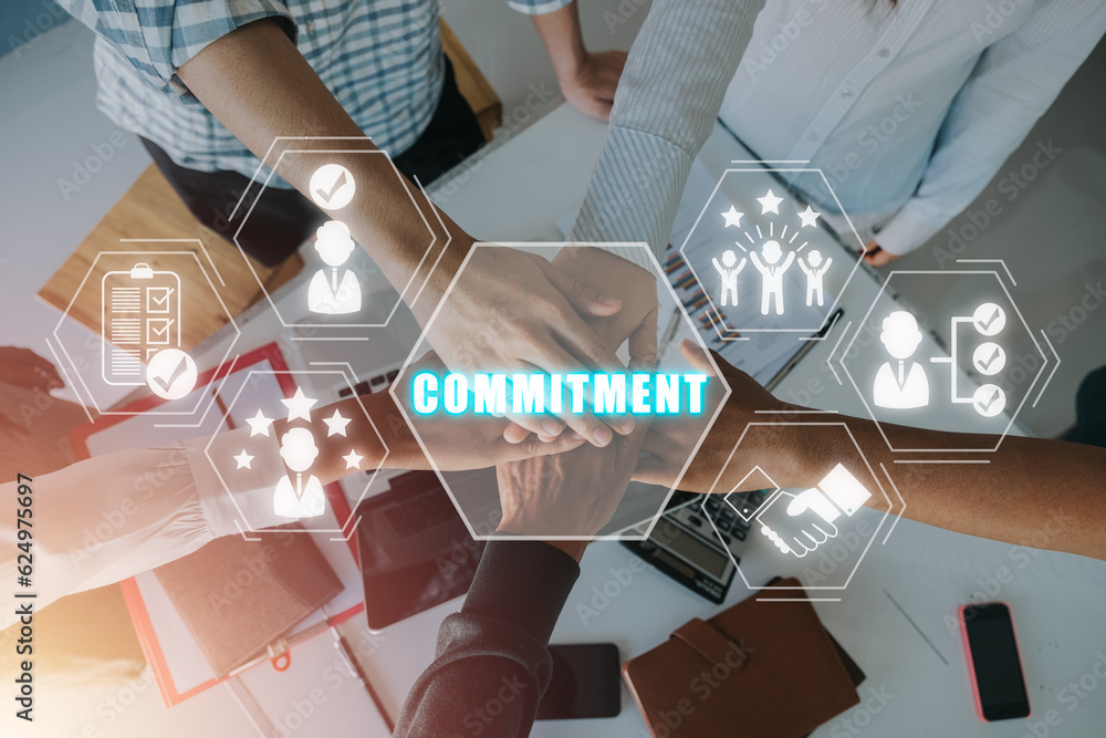 Poster commitment concept, multiracial business team signalling their commitment to each other by reaching 