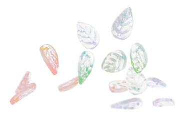 Fashion colorful plastic leaf with beautiful work detail is value. Luxury leaf bead red blue green is fashion trend and fly in air. Black background isolated selective focus blur