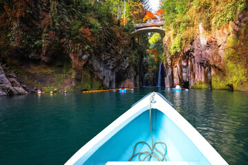 Fototapeta premium Miyazaki, Japan - Nov 24 2022: Takachiho Gorge is a narrow chasm cut through the rock by the Gokase River, plenty activities for tourists such as rowing and trekking through beautiful nature