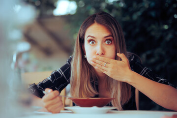 Woman Trying Food Feeling Sick Instantly from first Chewing. Restaurant customer Feeling nauseated and displeased with the serving  - obrazy, fototapety, plakaty