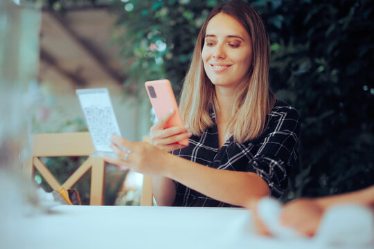 Woman Scanning QR Code for Restaurant Menu using Mobile App. Cheerful woman using technology in a diner to order and pay


