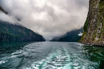 Cruising in a large catamaran past Mitre Peak and many waterfalls through the Milford Sound