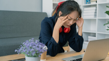 Asian student young woman stress while study on laptop, Asian young woman had headache while study