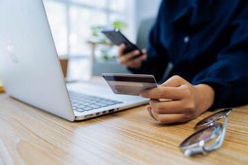 Young woman use credit card for online shopping on internet website. Online shopping, e-commerce, internet banking, spending money.