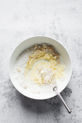 Creaming butter and sugar with a whisk, the process of making a cake, mixing butter and sugar to...
