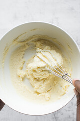 Creaming butter and sugar with a whisk, the process of making a cake, mixing butter and sugar to make a cake	