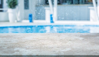 Empty table on swimming pool background in tropical resort
