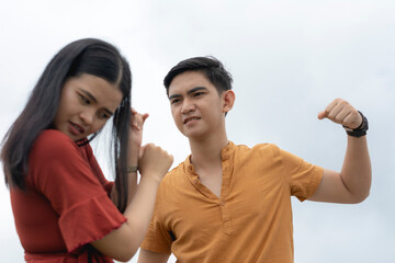 An angry young asian man threatens to hit his fearful girlfriend with his fists. A woman defends...
