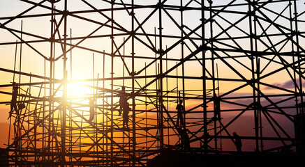 Group of construction workers working on scaffolding