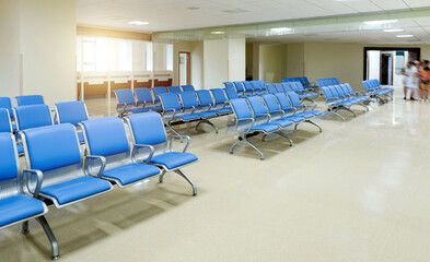 Hospital waiting room with row of empty chairs