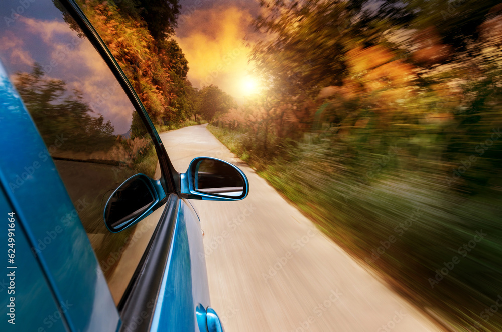 Poster car driving fast into forest with blurred motion