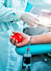 Male blood donor at the lab with a bouncy ball holding in hand