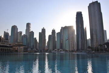 Fototapeta na wymiar Dubai mall fountain and modern downtown buildings