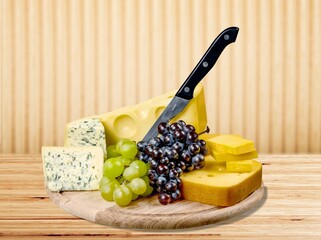 Wooden board with fresh tasty cheese
