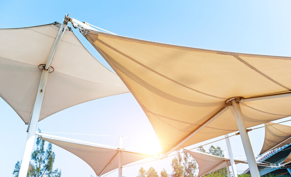 White awnings in sails shape under blue sky