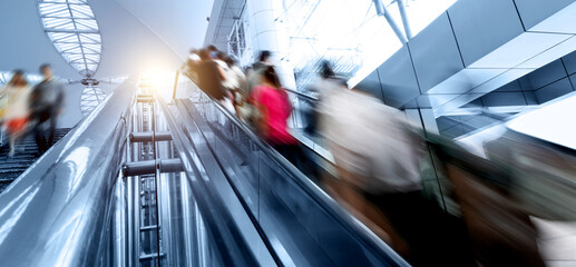 People rush on escalator motion blurred © xy