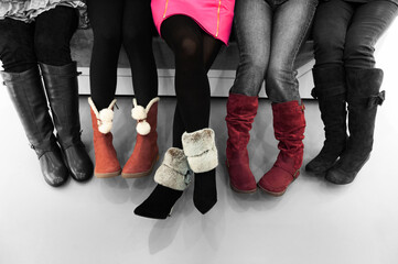 Five girls sitting together and putting on their boots