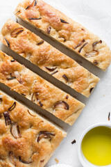 Top view of homemade onion focaccia on a white background, Flatlay of focaccia with red onion topping, fresh homemade focaccia bread