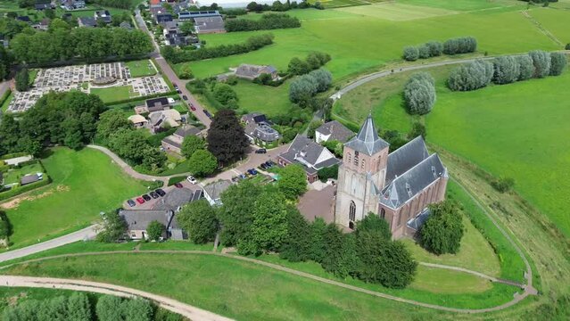 Orbit view of little church in grassland, small village.