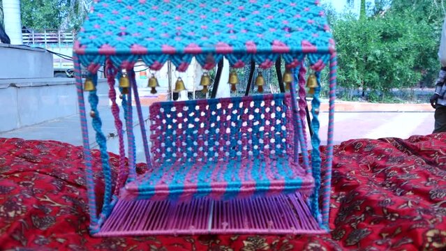 blue and pink tent of Swing For Hindu Gods. Blue knitwork swing .Swing Moving