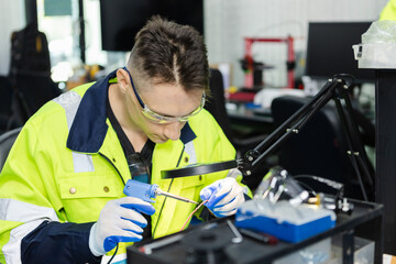 man electrical engineer using solder repairing instrument cable microchip board. repairman worker...