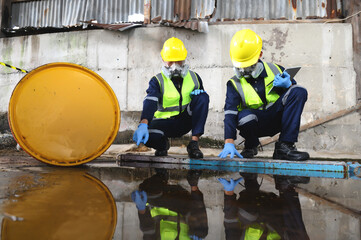 Two Officers of Environmental Engineering Wearing Protective Equipment with Gas Masks Inspected Oil...