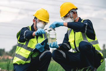 Two Environmental Engineers Take Water Samples at Natural Water Sources Near Farmland Maybe Contaminated by Toxic Waste or Suspicious Pollution Sites